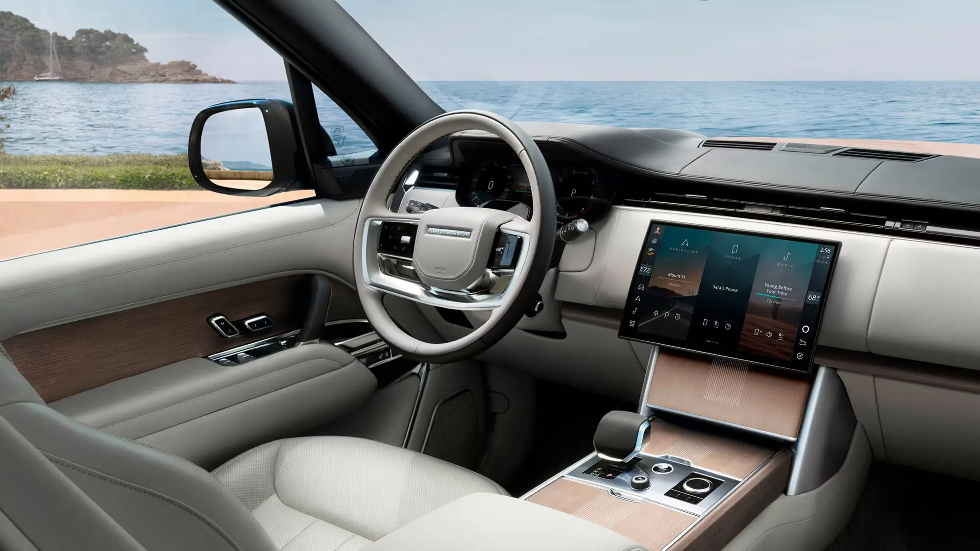 Light leather Range Rover Autobiography cabin with Pivi Pro touchscreen and wood veneer