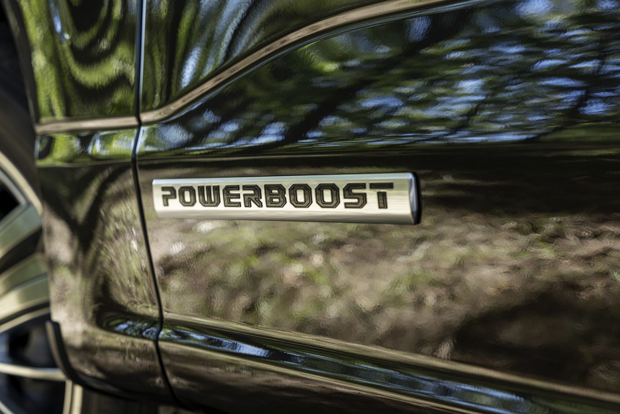 Close-up of the PowerBoost badge on a Ford F-150 PowerBoost Hybrid pickup truck