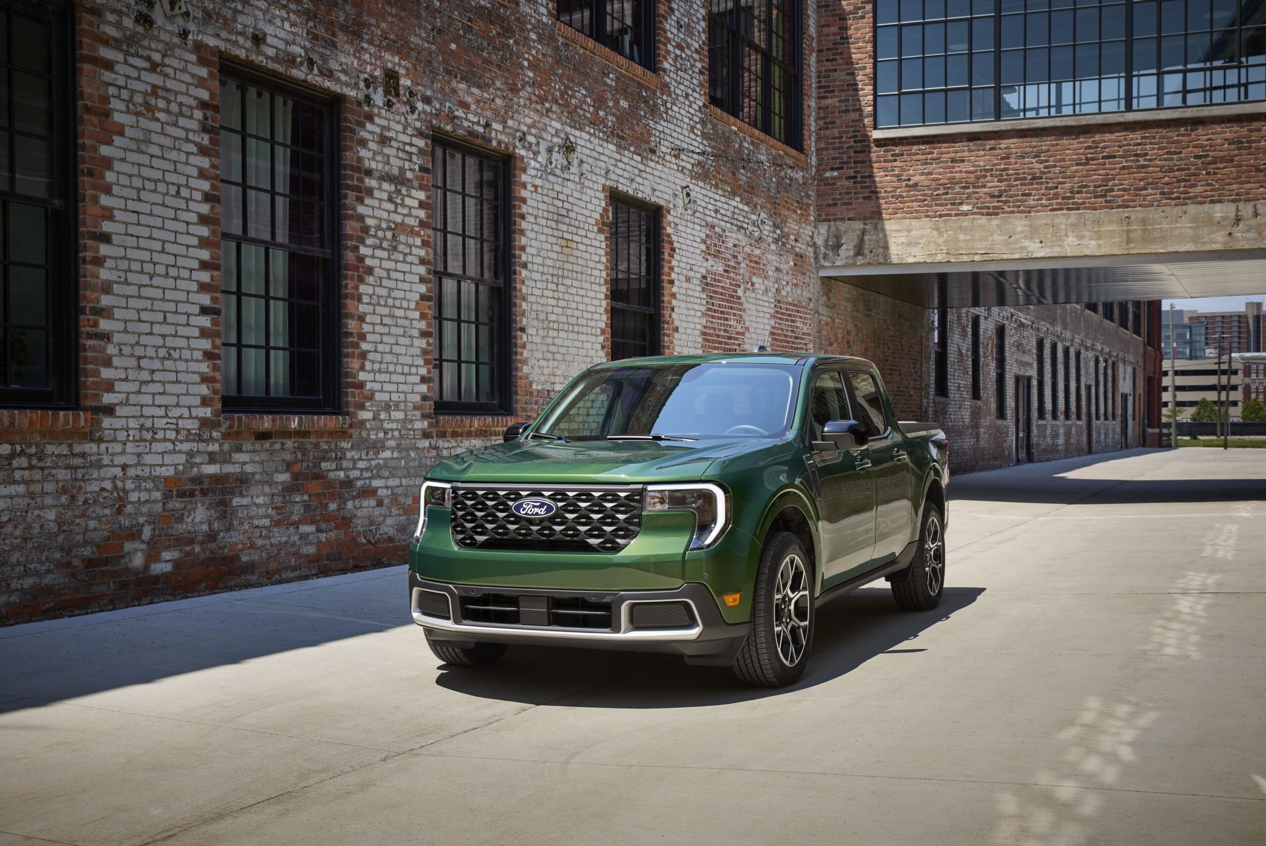 2025 Ford Maverick Lariat pickup truck parked outside an urban brick building