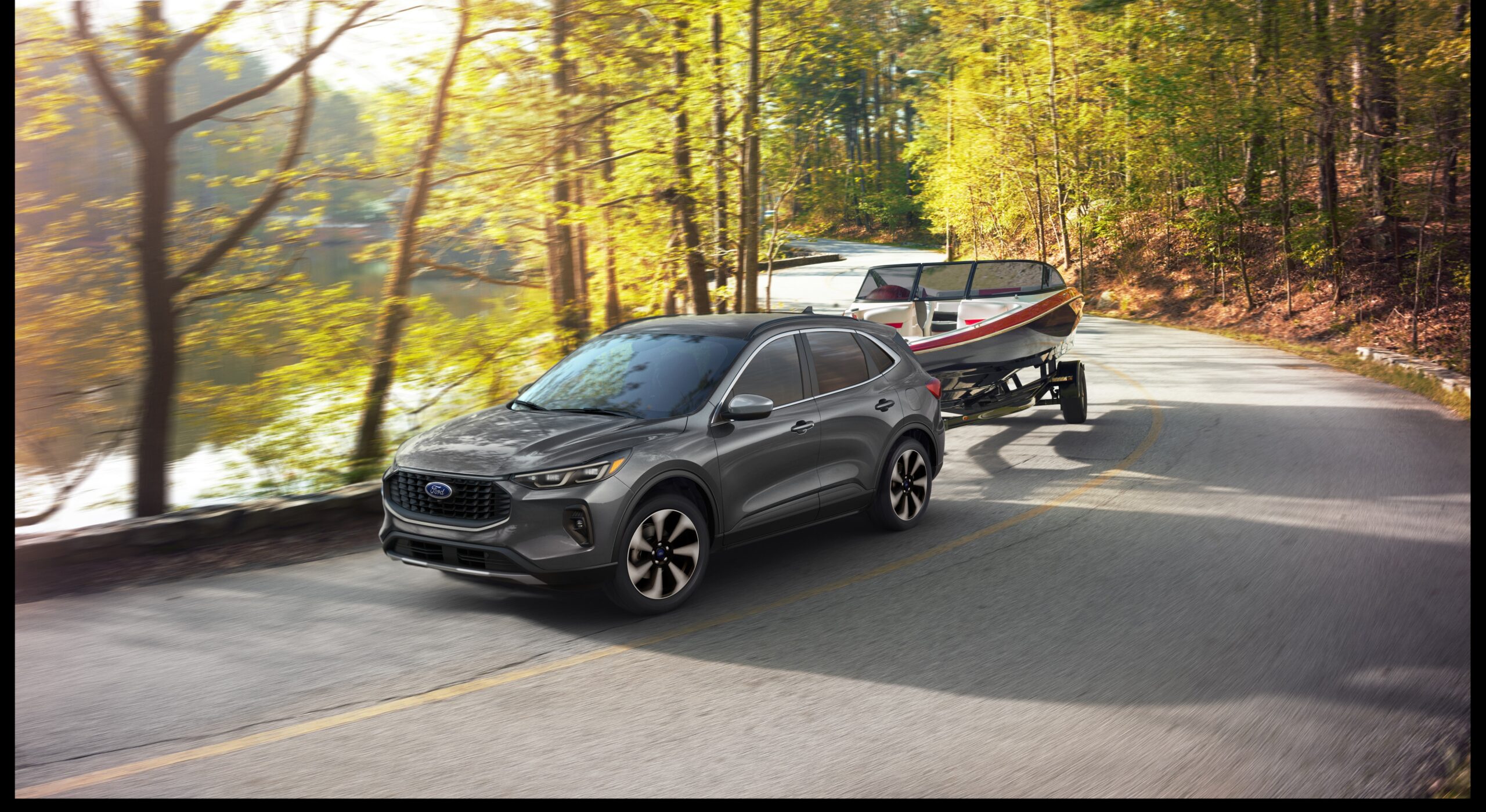 2025 Ford Escape Platinum towing a small boat on a wooded road