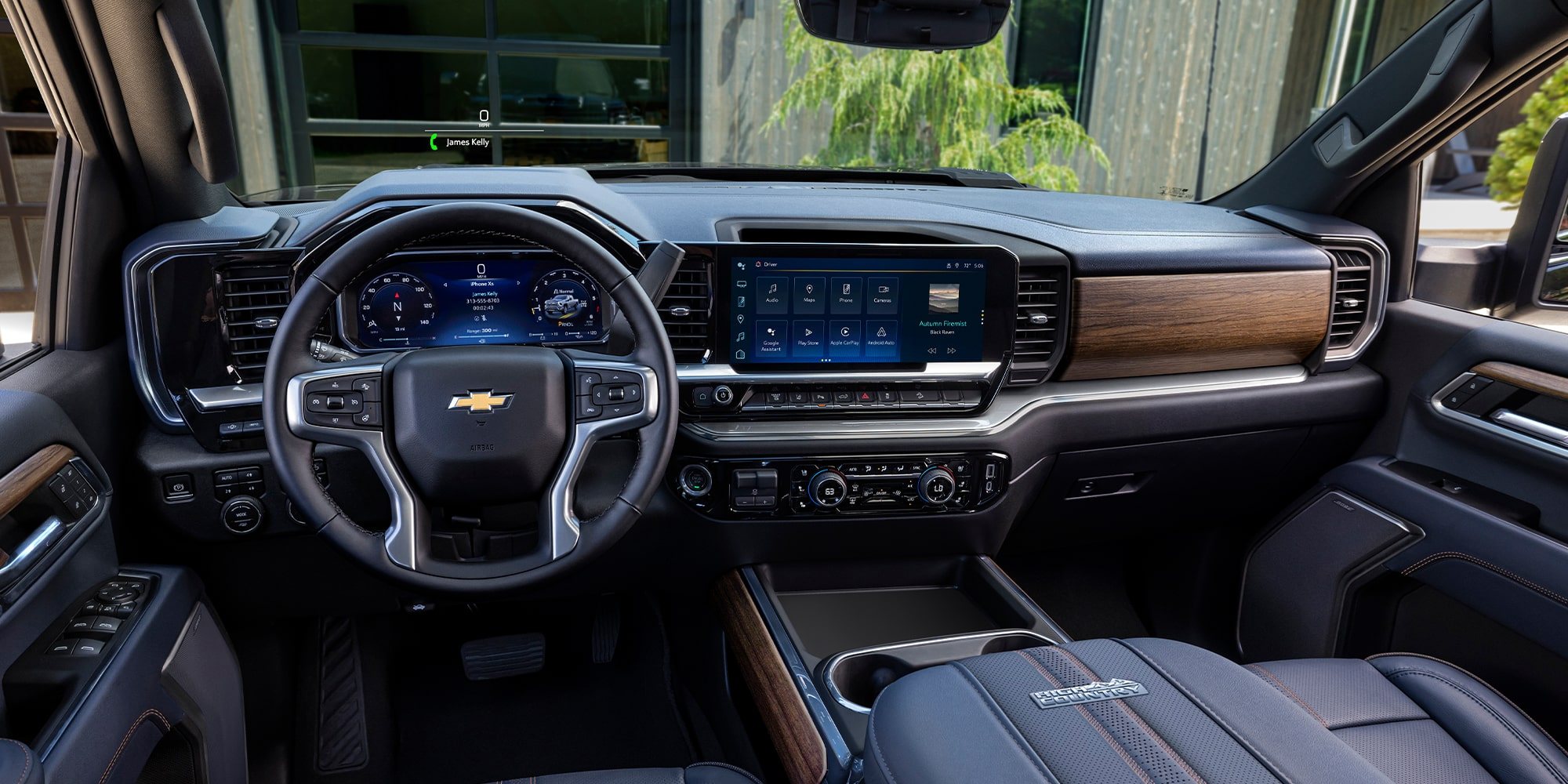 Silverado HD High Country dashboard with a digital driver display, center touchscreen and wood-grain trim